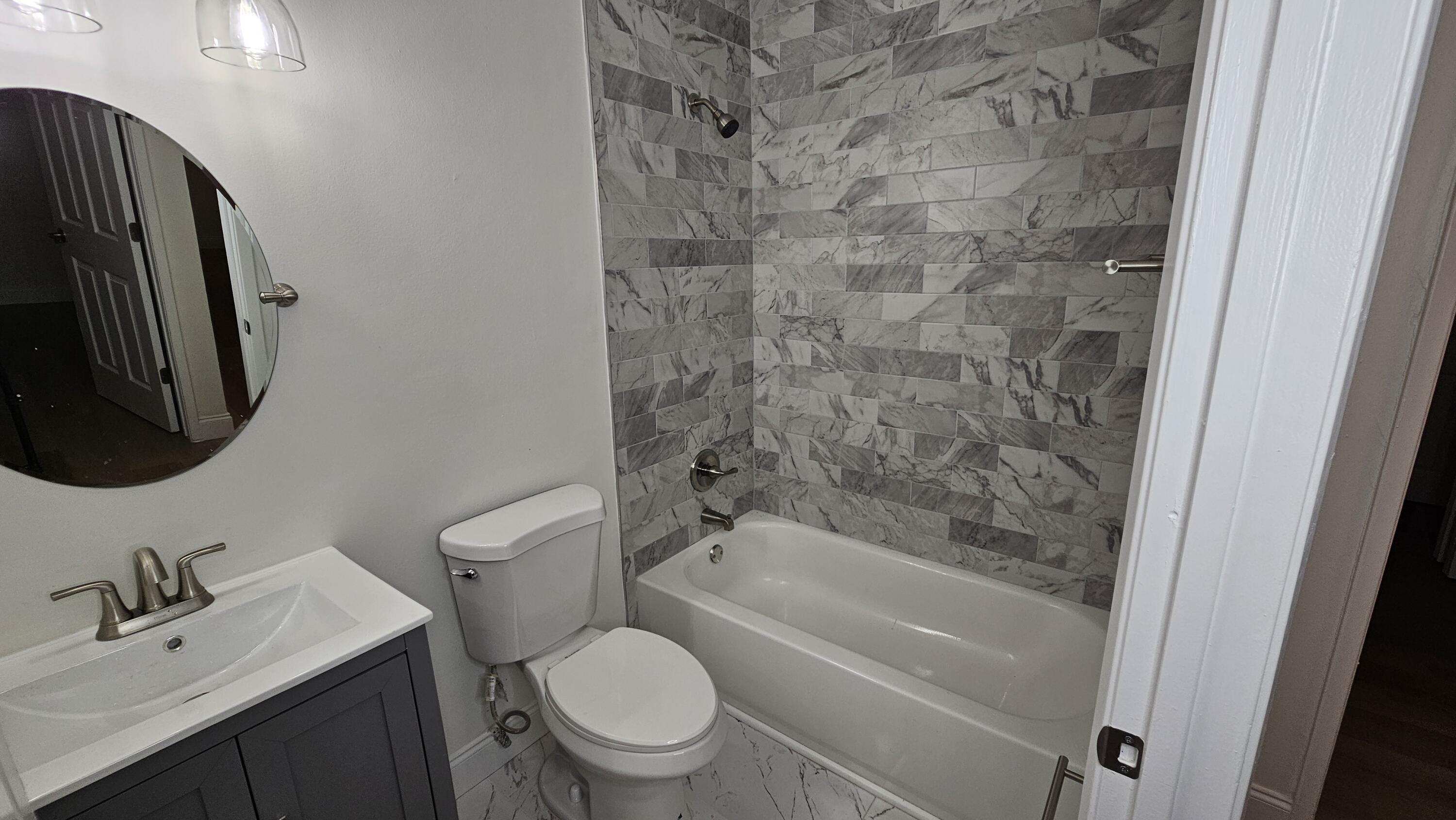 18974 Cloud Lake Circle Boca Raton, FL 33496 - Photo 20 of 29 a bathroom with a granite countertop toilet sink and mirror