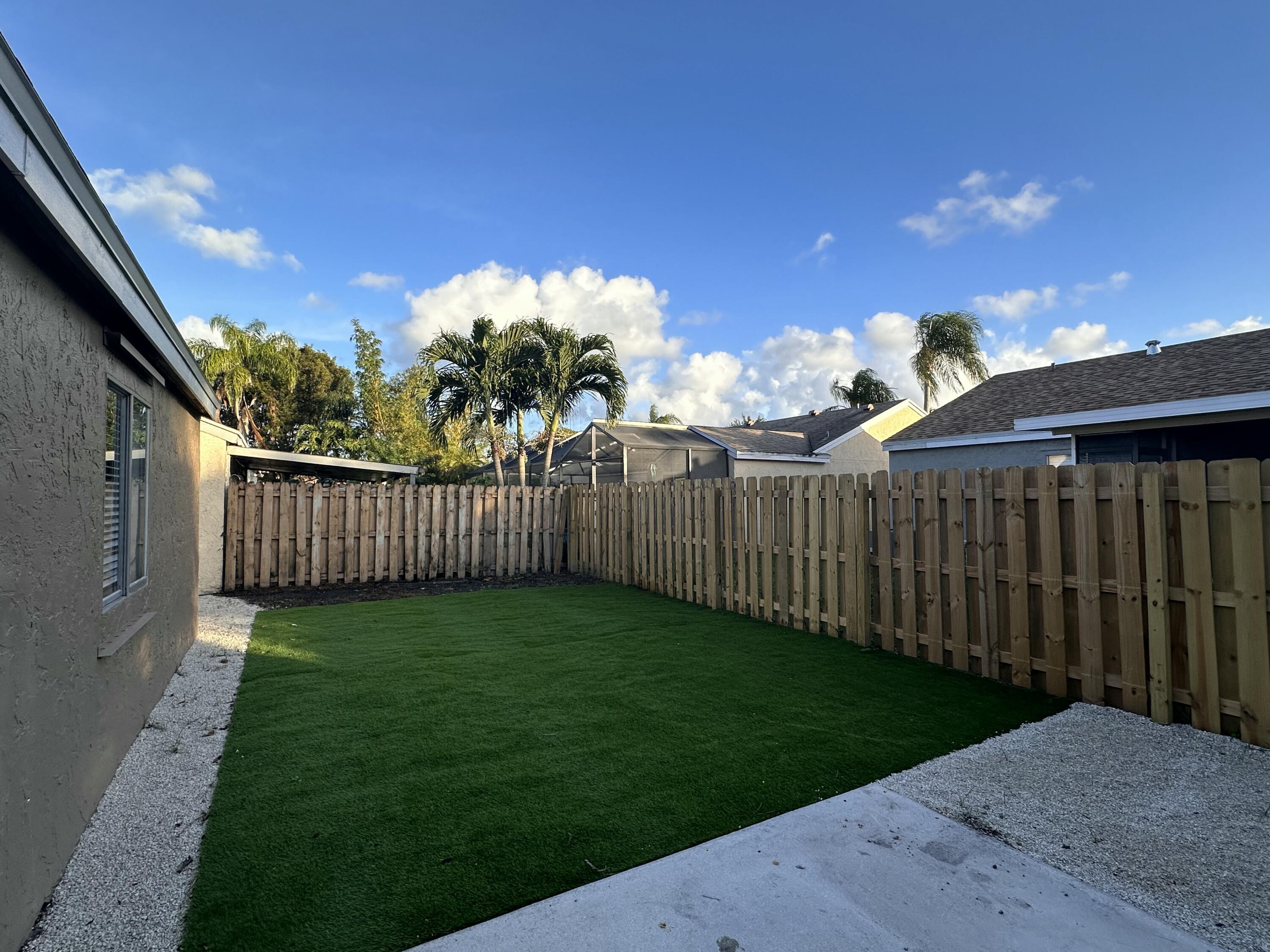 18974 Cloud Lake Circle Boca Raton, FL 33496 - Photo 23 of 29 a view of a backyard with wooden fence