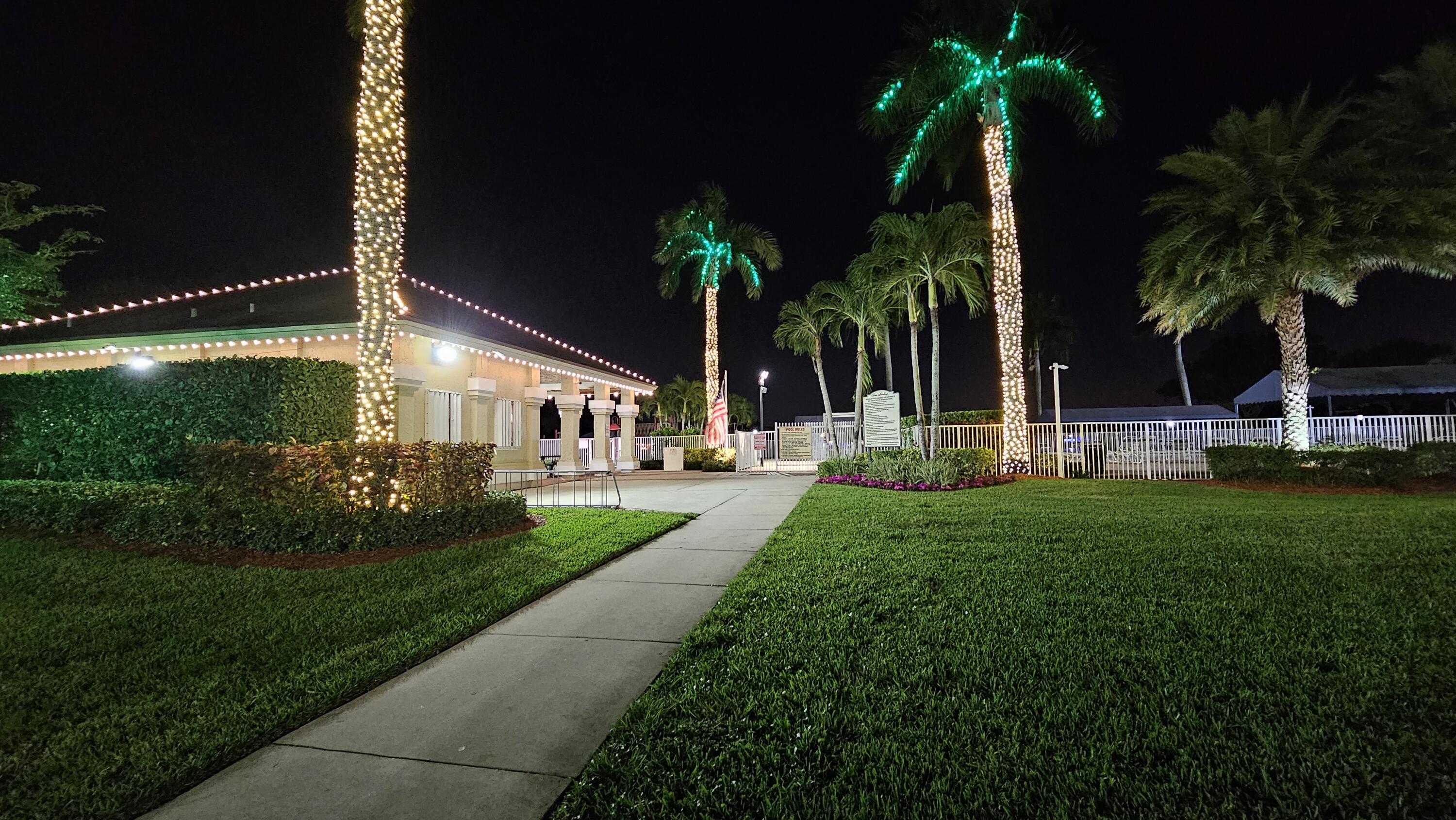 18974 Cloud Lake Circle Boca Raton, FL 33496 - Photo 25 of 29 a view of a house with a yard and palm trees