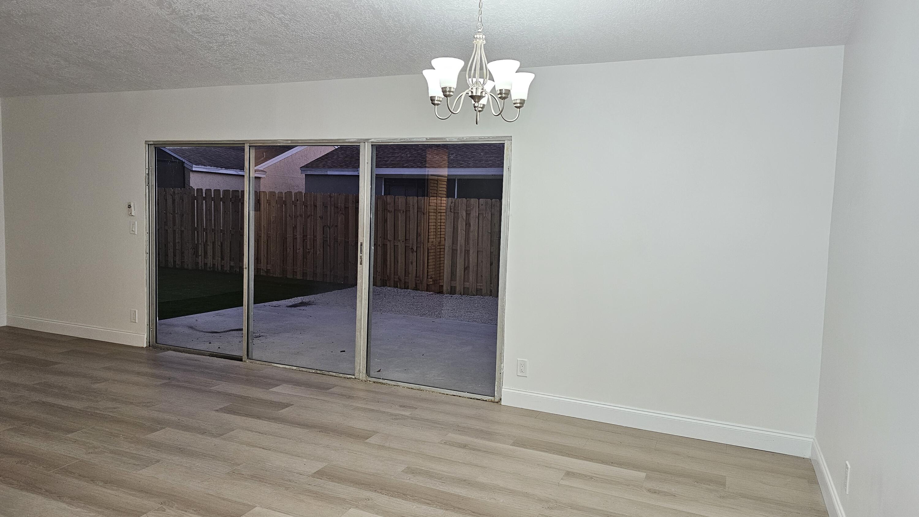 18974 Cloud Lake Circle Boca Raton, FL 33496 - Photo 7 of 29 a view of a chandelier fan and wooden floor