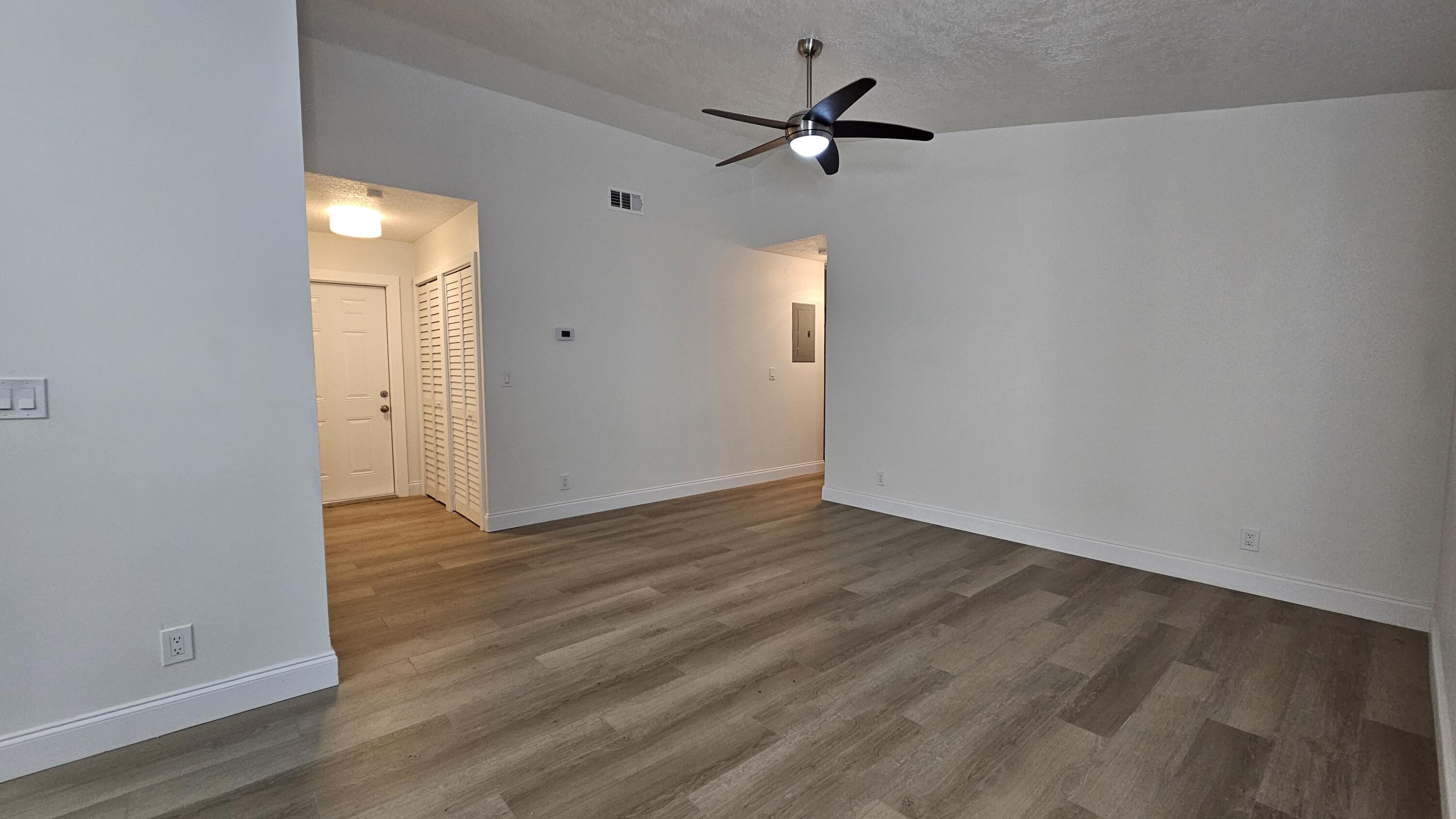 18974 Cloud Lake Circle Boca Raton, FL 33496 - Photo 10 of 29 a view of a livingroom with wooden floor and a ceiling fan
