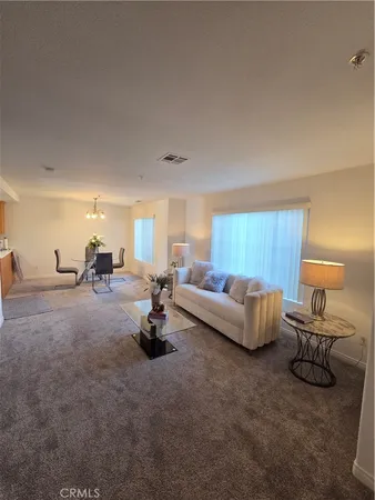 a living room with furniture and a lamp
