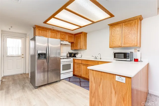 a kitchen with stainless steel appliances a refrigerator and a stove