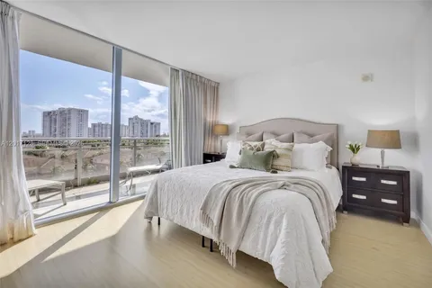 a bedroom with a large bed and a large window