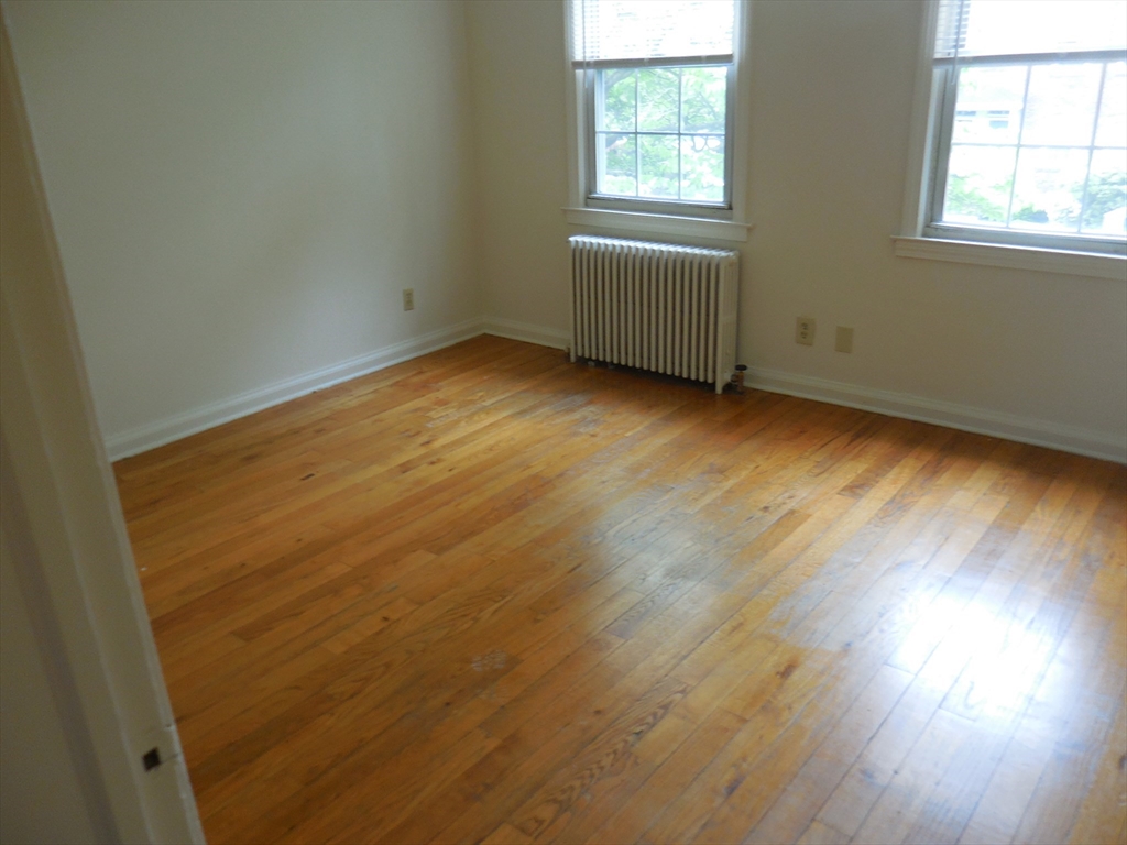 6 Colony Road, Unit 6 West Springfield, MA 01089 - Photo 13 of 17 an empty room with wooden floor and windows