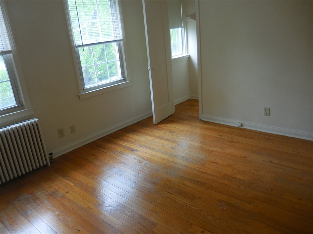 6 Colony Road, Unit 6 West Springfield, MA 01089 - Photo 14 of 17 an empty room with wooden floor and windows
