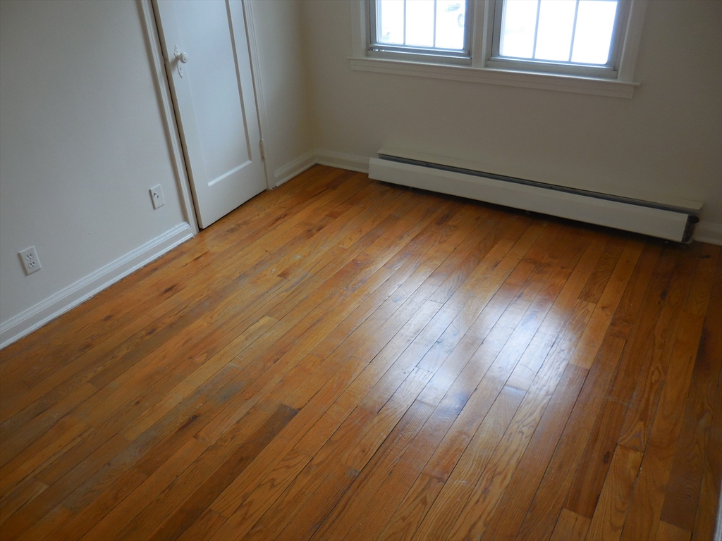 6 Colony Road, Unit 6 West Springfield, MA 01089 - Photo 15 of 17 an empty room with wooden floor and windows