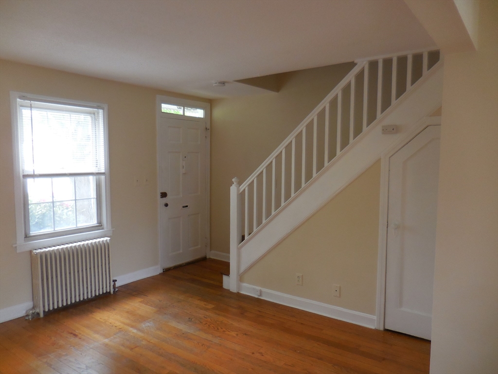 6 Colony Road, Unit 6 West Springfield, MA 01089 - Photo 8 of 17 a view of an empty room with wooden floor and windows