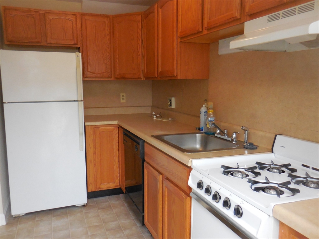 6 Colony Road, Unit 6 West Springfield, MA 01089 - Photo 9 of 17 a kitchen with a stove and a refrigerator