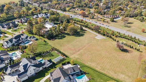 an aerial view of residential building and lake