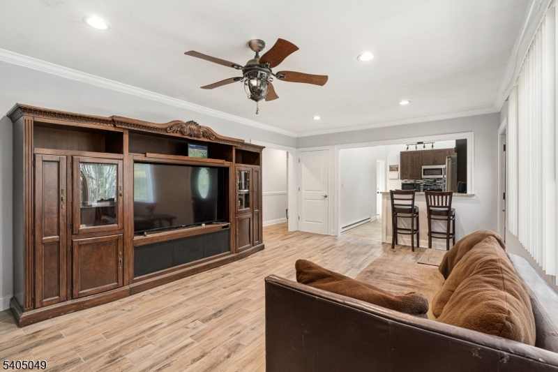 148 Highway 94 Vernon, NJ 07462 - Photo 11 of 33 a living room with stainless steel appliances granite countertop furniture a flat screen tv and a view of kitchen