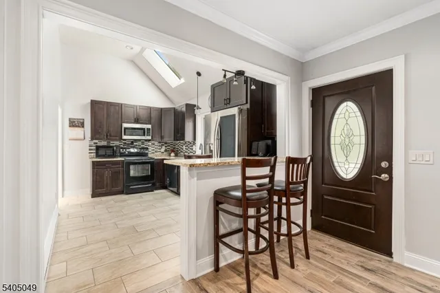 a kitchen with stainless steel appliances granite countertop a refrigerator a stove a sink and dishwasher