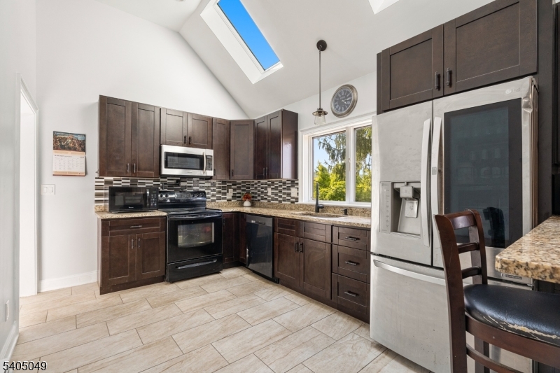 148 Highway 94 Vernon, NJ 07462 - Photo 15 of 33 a kitchen with stainless steel appliances granite countertop a refrigerator a stove a sink and dishwasher