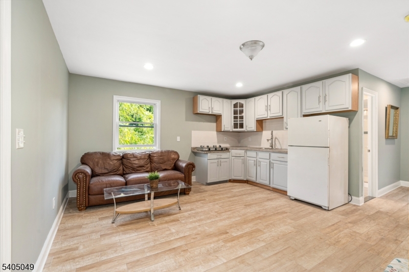 148 Highway 94 Vernon, NJ 07462 - Photo 17 of 33 a kitchen with white cabinets and white appliances
