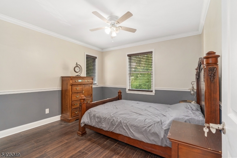 148 Highway 94 Vernon, NJ 07462 - Photo 28 of 33 a bedroom with a bed and a chandelier