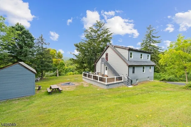 a view of a roof deck with table and chairs and wooden floor