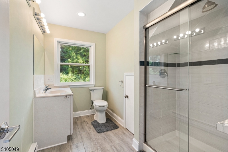 148 Highway 94 Vernon, NJ 07462 - Photo 4 of 33 a bathroom with a granite countertop shower a toilet and a sink