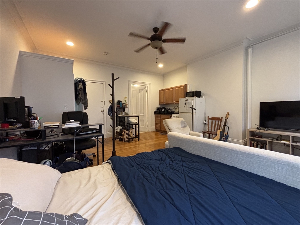 98 Charles Street, Unit 1 Boston, MA 02114 - Photo 4 of 9 a living room with furniture and a flat screen tv