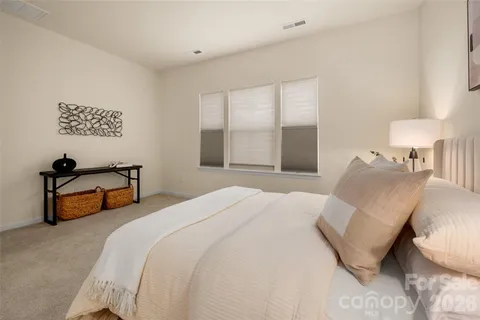 a bedroom with bed and a night stand