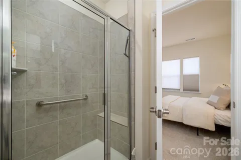 a en suite bathroom with a white shower and a sink
