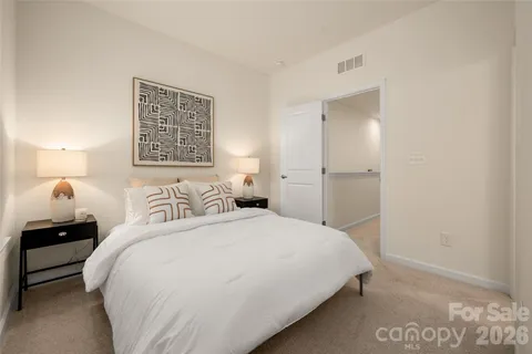 a bedroom with a bed and a lamp