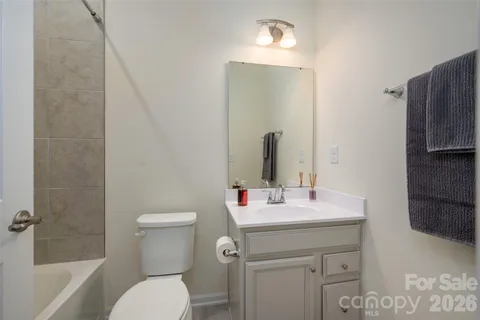 a bathroom with a sink toilet vanity and shower