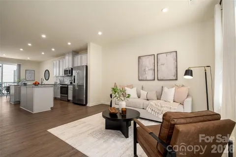 a living room with furniture and kitchen view