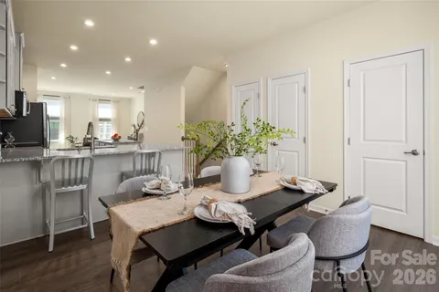 a dining room with furniture and wooden floor