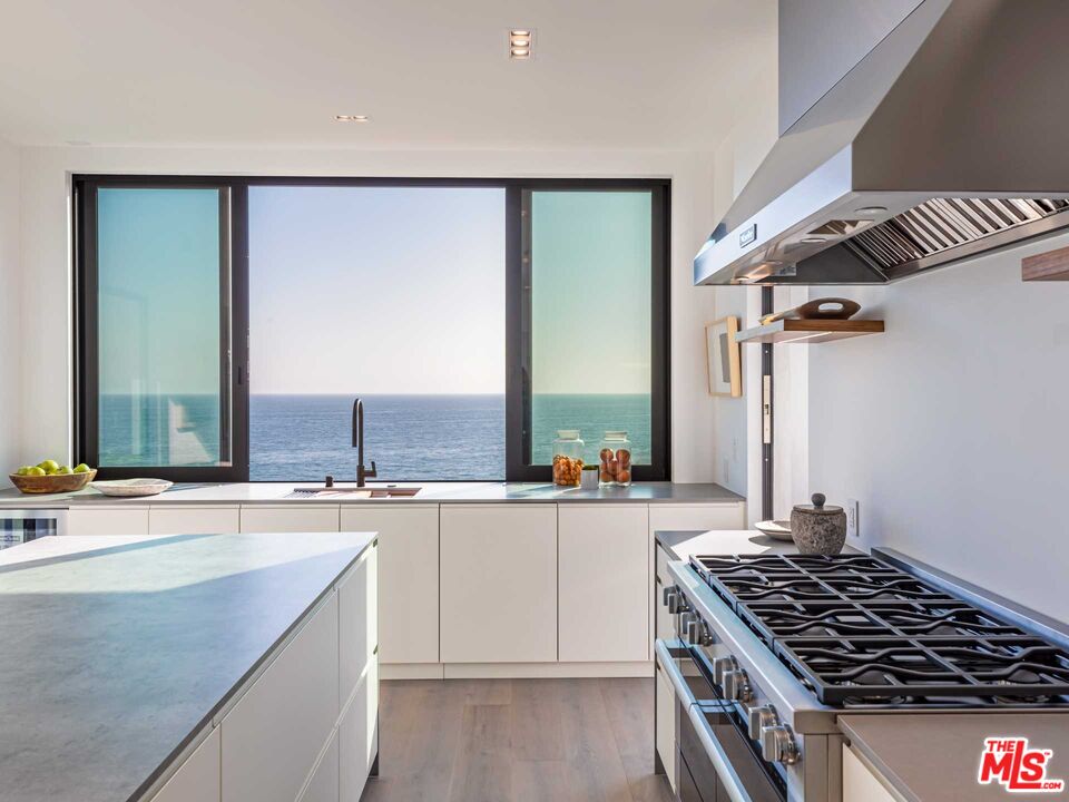 25225 Malibu Road Malibu, CA 90265 - Photo 12 of 23 a kitchen with a stove a sink and a refrigerator