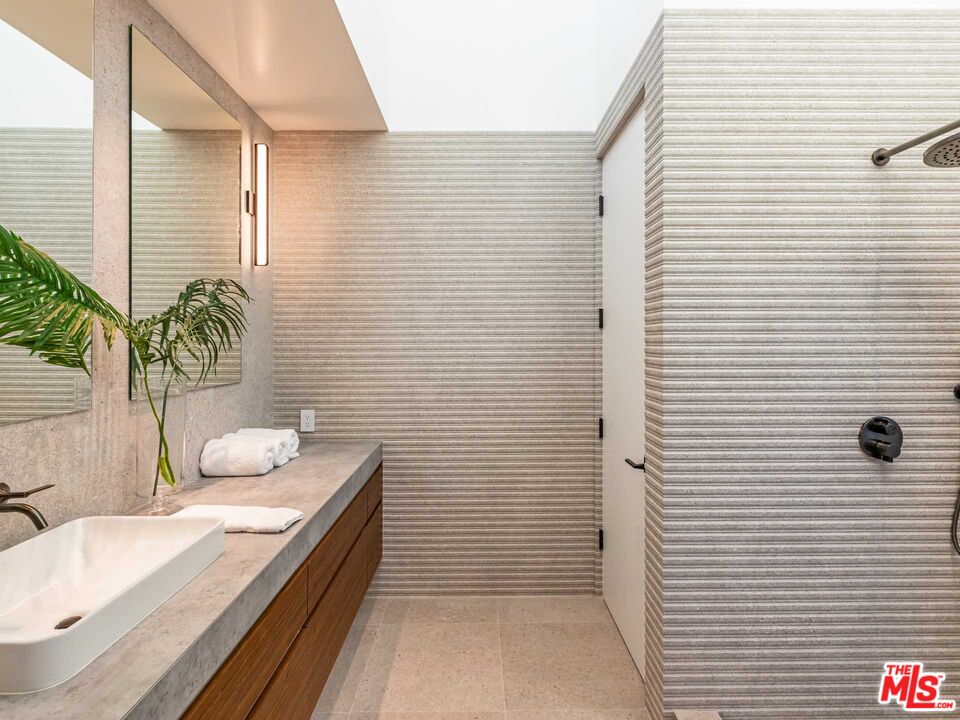 25225 Malibu Road Malibu, CA 90265 - Photo 15 of 23 a bathroom with a granite countertop sink a mirror and shower