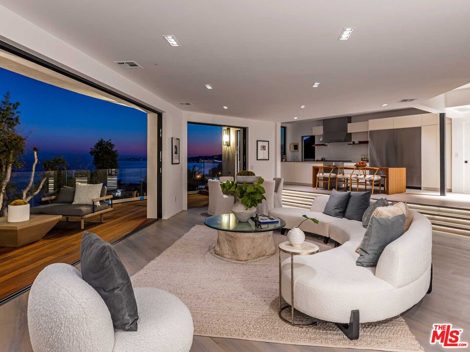 25225 Malibu Road Malibu, CA 90265 - Photo 21 of 23 a living room with furniture kitchen view and a large window