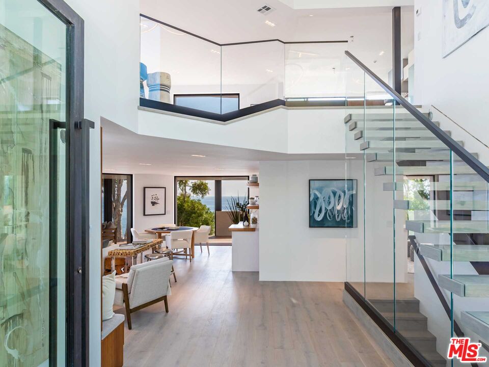 25225 Malibu Road Malibu, CA 90265 - Photo 3 of 23 a view of a livingroom with furniture wooden floor and a chandelier