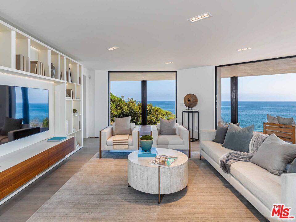 25225 Malibu Road Malibu, CA 90265 - Photo 5 of 23 a living room with furniture and a large window