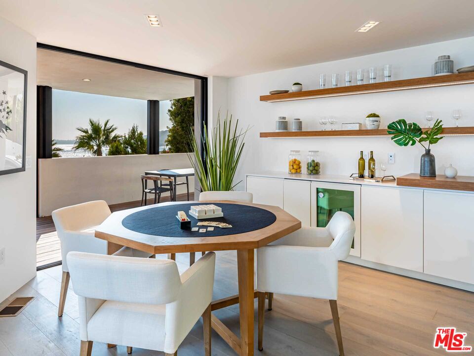 25225 Malibu Road Malibu, CA 90265 - Photo 6 of 23 a dining room with furniture and wooden floor