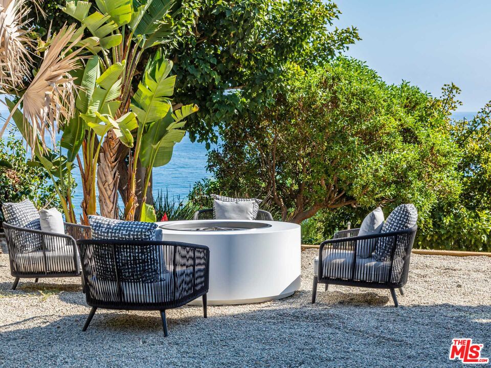25225 Malibu Road Malibu, CA 90265 - Photo 8 of 23 a view of a chairs and table in the backyard