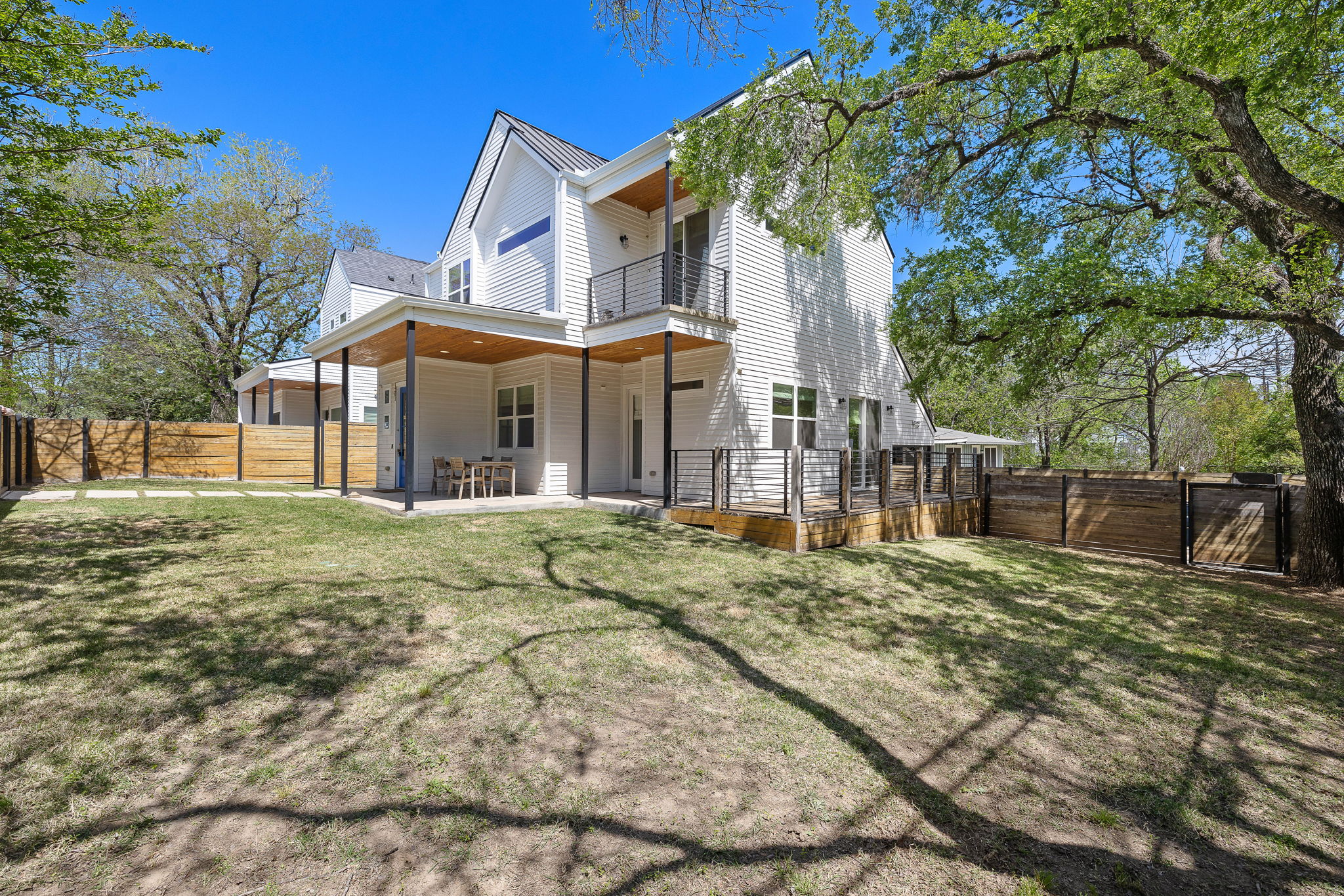 1201 Luna Street Austin, TX 78721 - Photo 10 of 31 a view of a white house with a large tree and plants