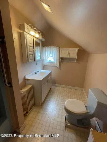 a bathroom with a sink a toilet and mirror