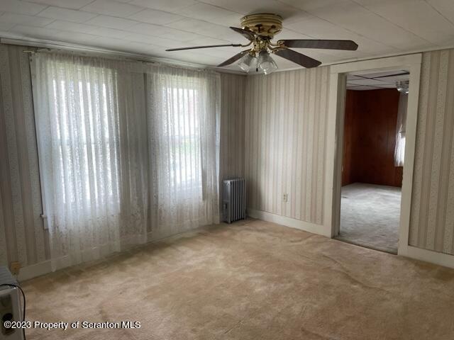 3511-3513 Winfield Avenue Moosic, PA 18507 - Photo 20 of 23 an empty room with windows and fan
