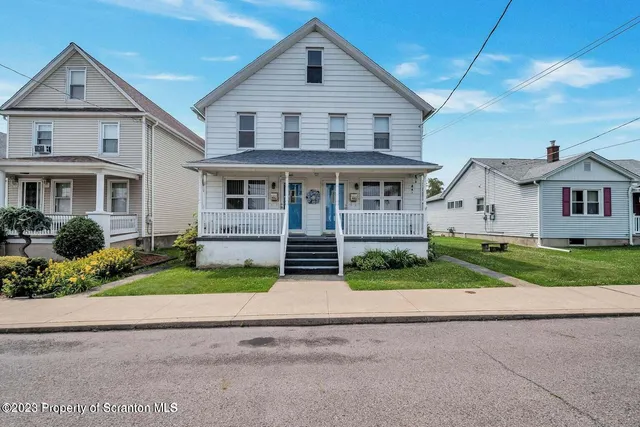 a view of house that has a yard