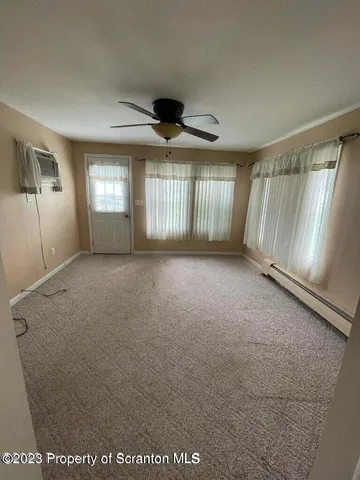 a view of an empty room with a window