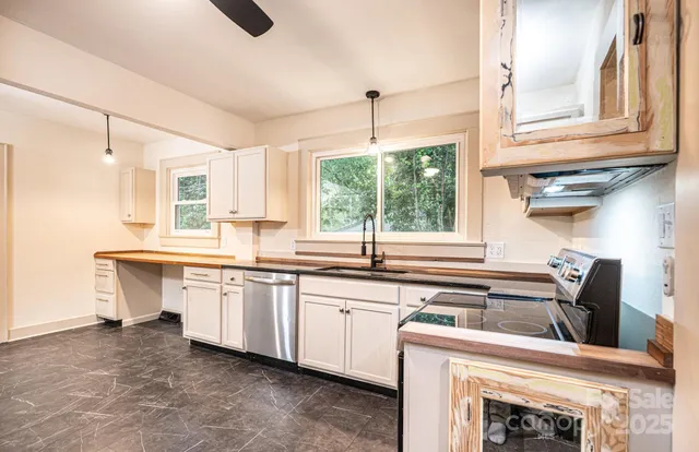 a kitchen with sink cabinets and window