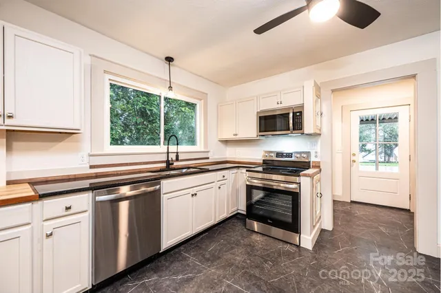 a kitchen with stainless steel appliances granite countertop a stove and a sink