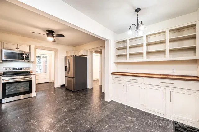 a kitchen with stainless steel appliances a stove and cabinets