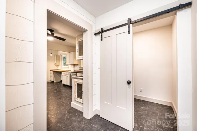 a view of a walk in closet and a bathroom with a shower
