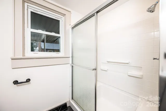 a view of staircase with railing and white walls