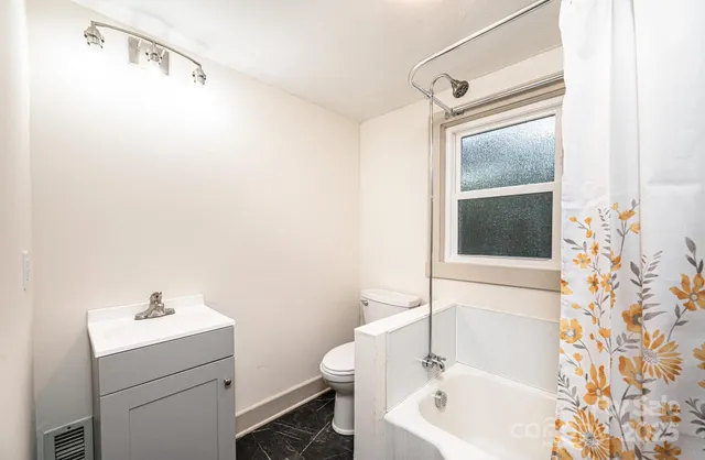 a view of a hallway with wooden floor and entryway
