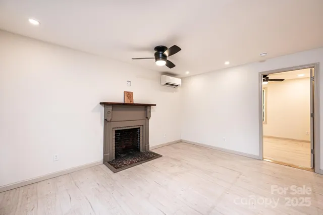 a view of kitchen with stainless steel appliances kitchen island hardwood floor and a sink