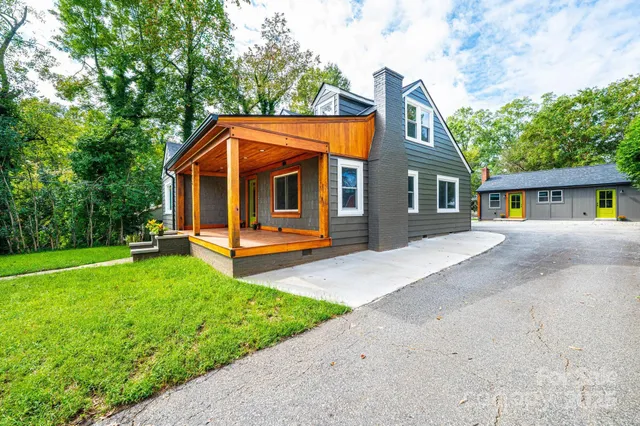 a front view of a house with yard and green space