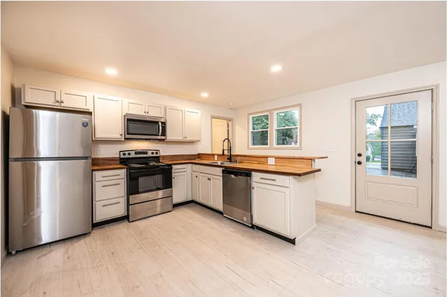 a view of an empty room and a fireplace