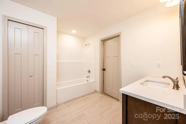a bathroom with a sink vanity and mirror